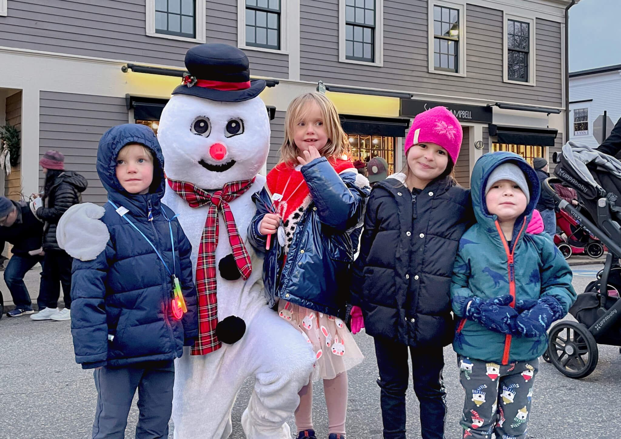 Georg Ove Andersen Mathiesen, Eva Margrethe Andersen Mathiesen, and Iris and Elliot Cameron make friends with Frosty the Snowman in downtown Concord Sunday. See a photo spread of the tree lighting festivities